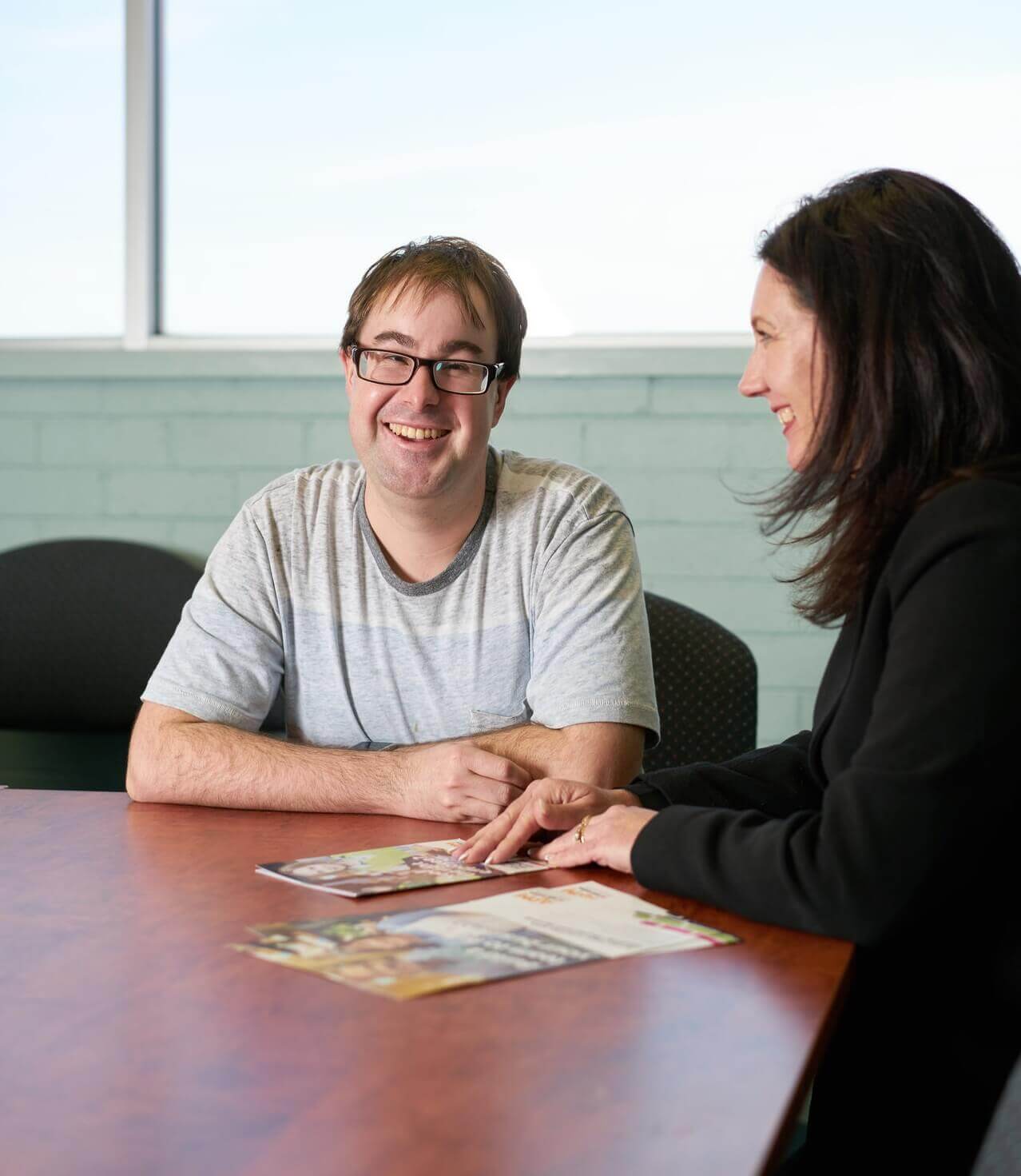 APM employee discussing with a man both laughing