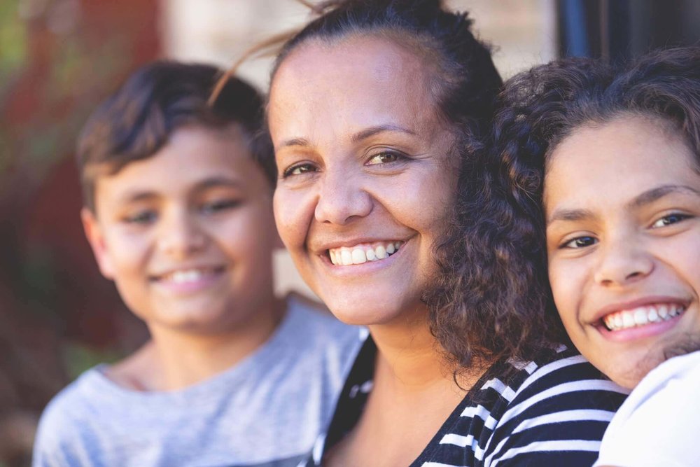 Parent with her two children smiling