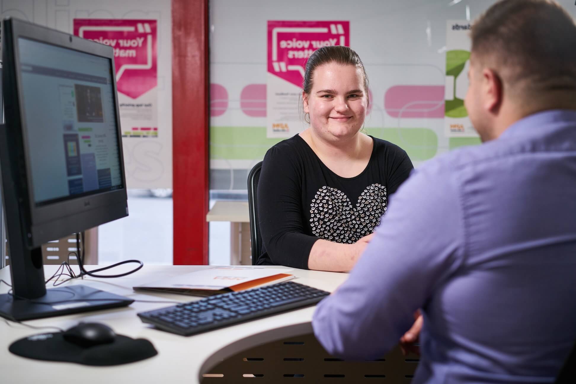 woman discussing with an APM employee smiling