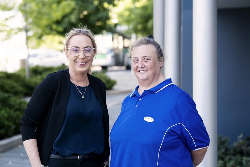 Georgie standing next to a woman smiling