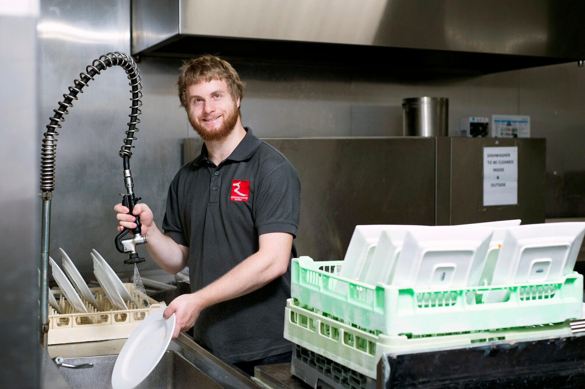 Bryn in the kitchen holding a tap