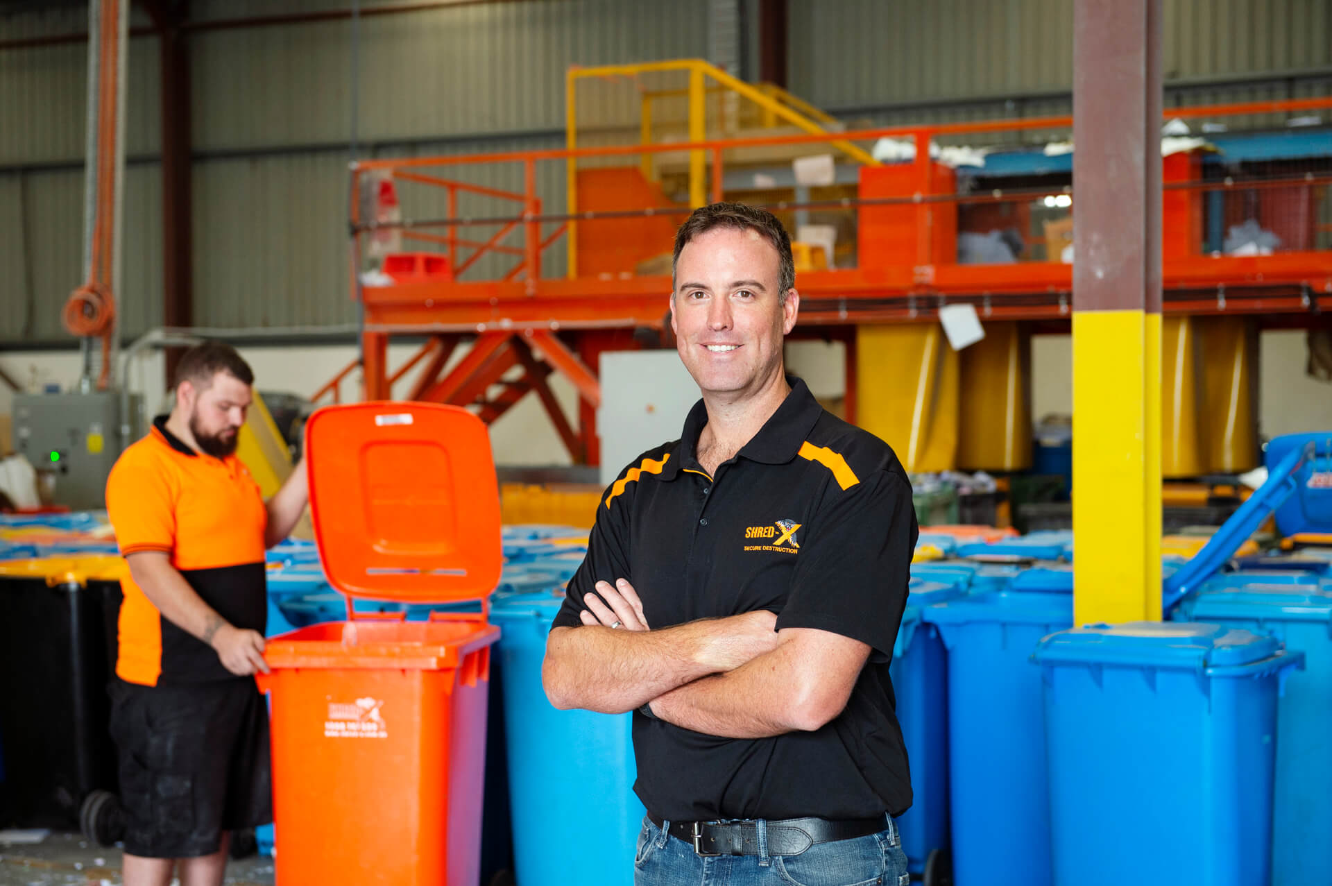 ShredX employee with folded arms smiling