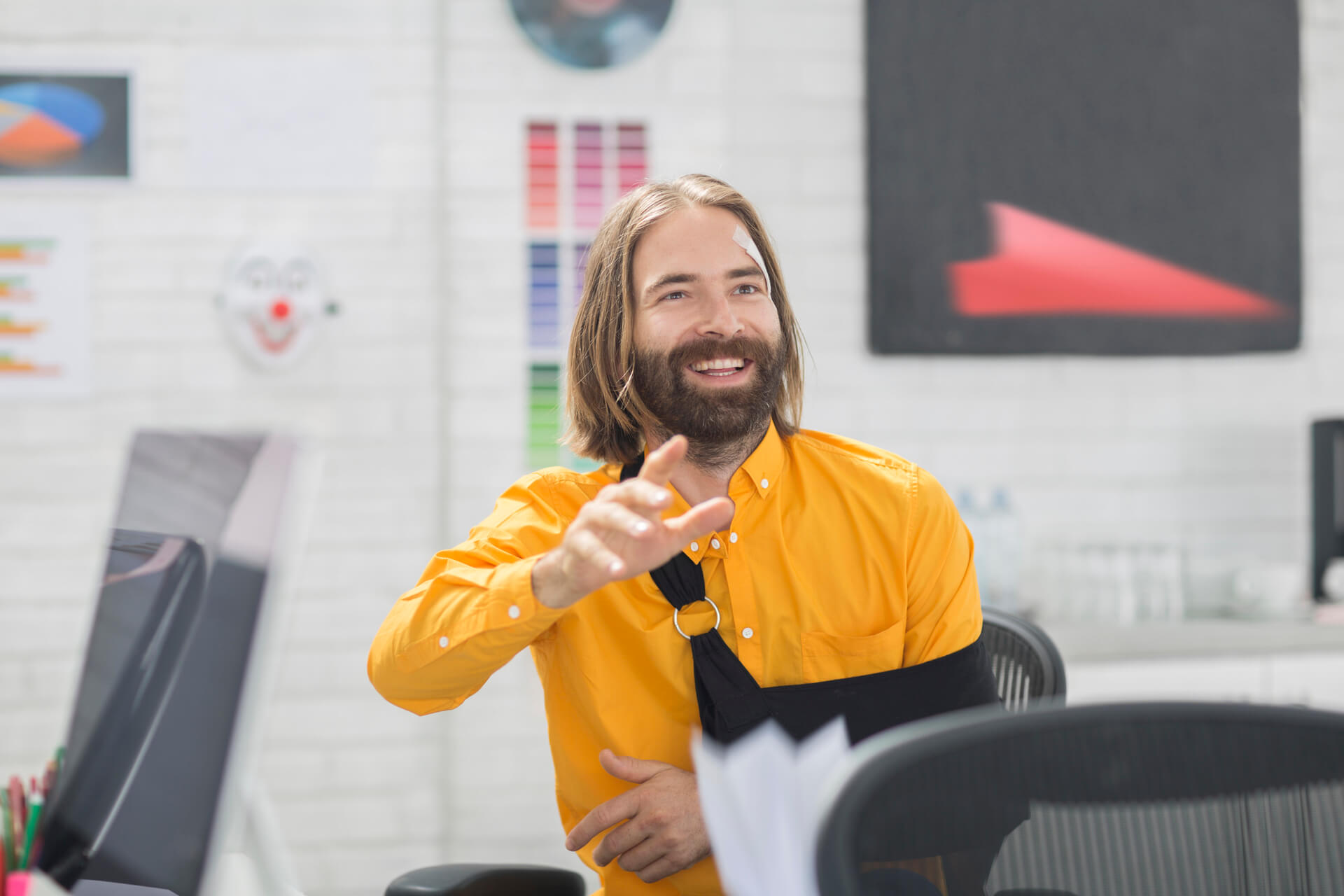 man in a sling waving