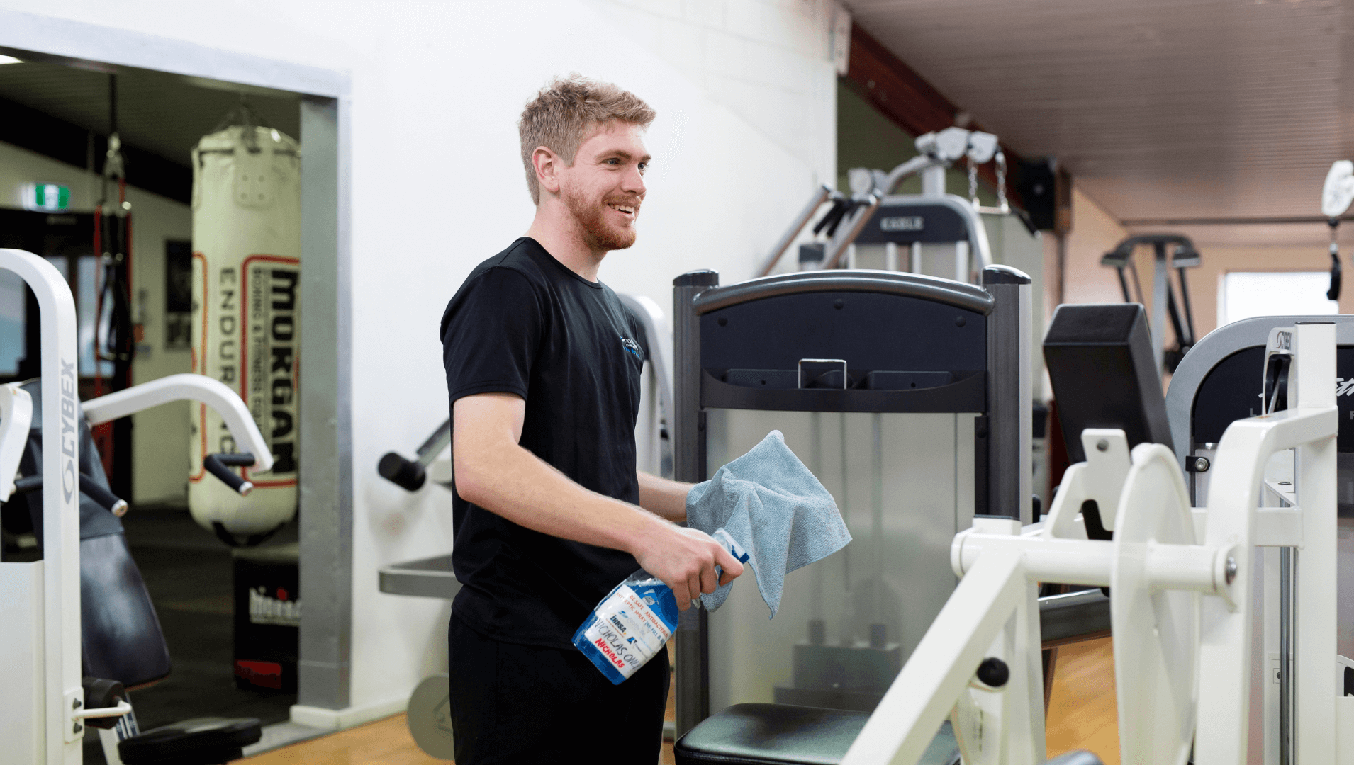 Nicholas cleaning gym equipment