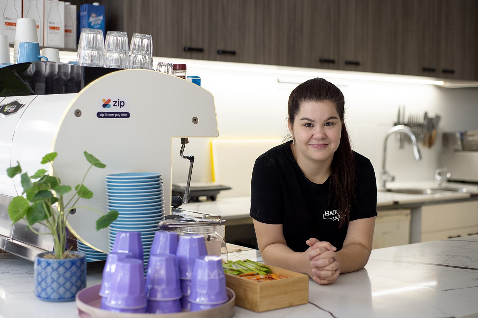 woman smiling behind a counter