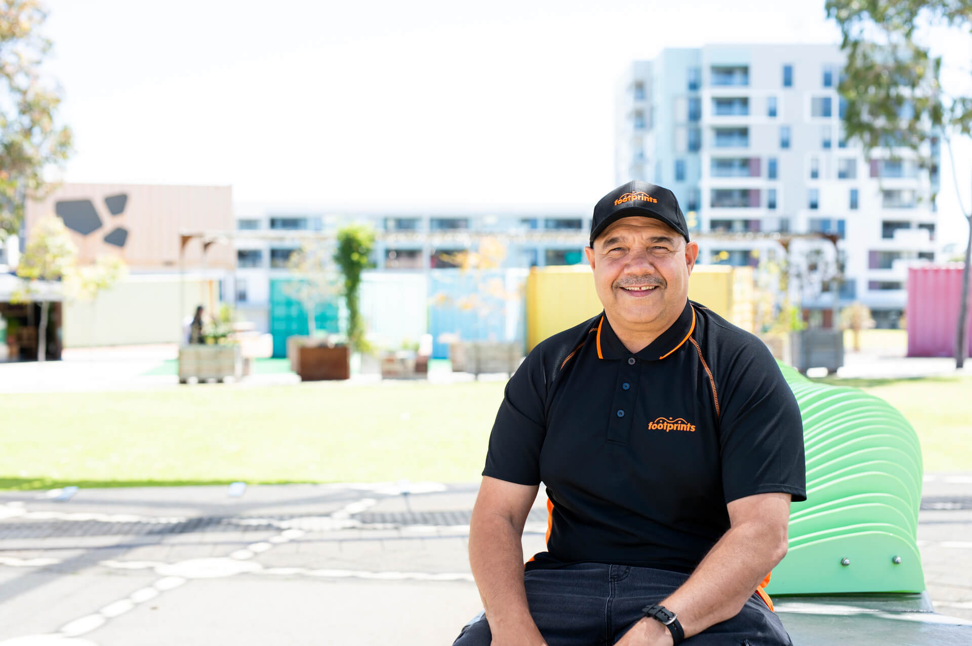 Brian a First Nations participant smiles in a black cap and top