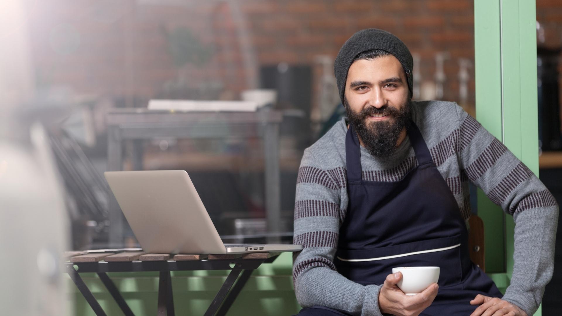 man smiling wearing an apron