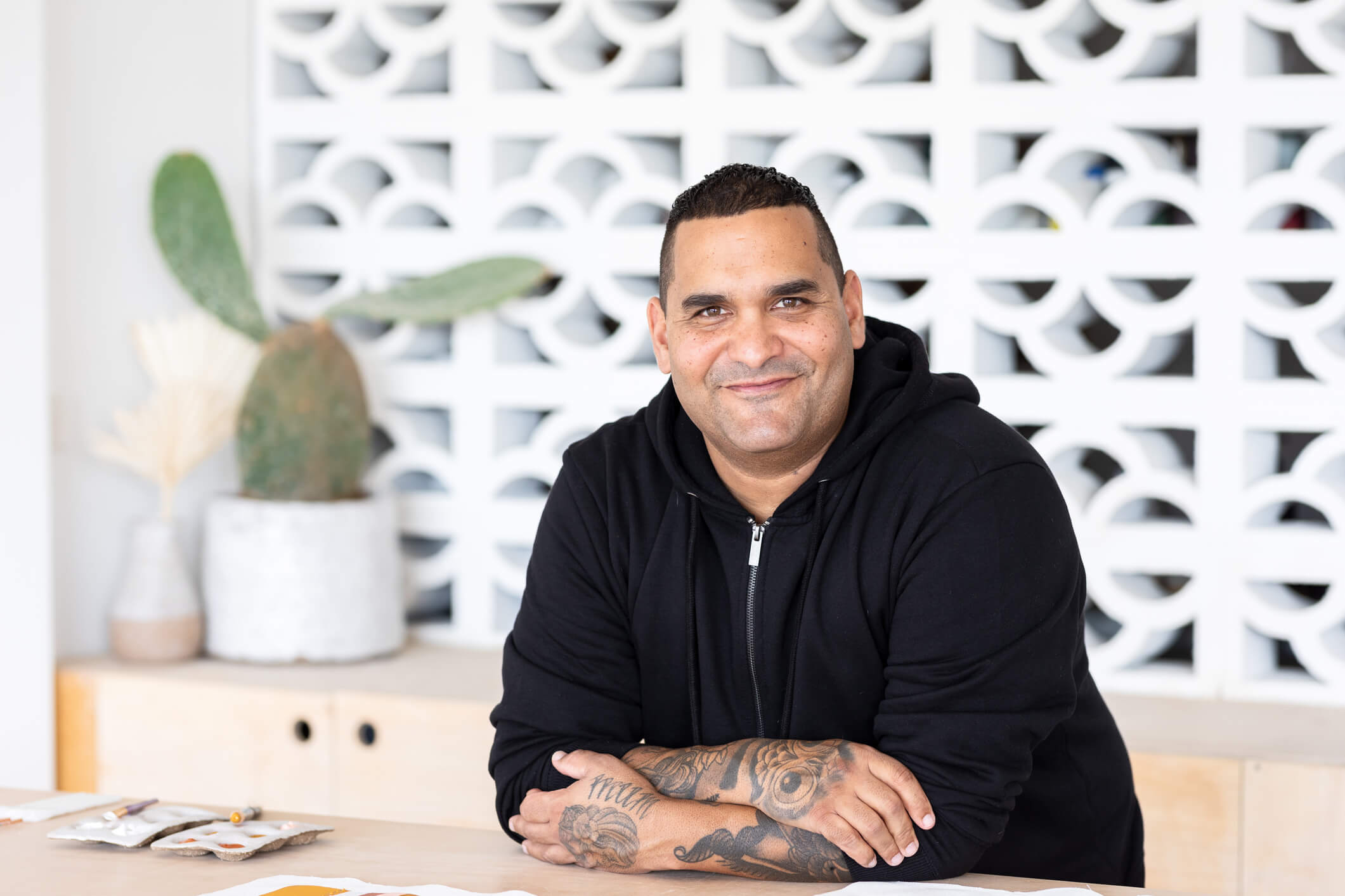 man leaning on a counter with his arms folded