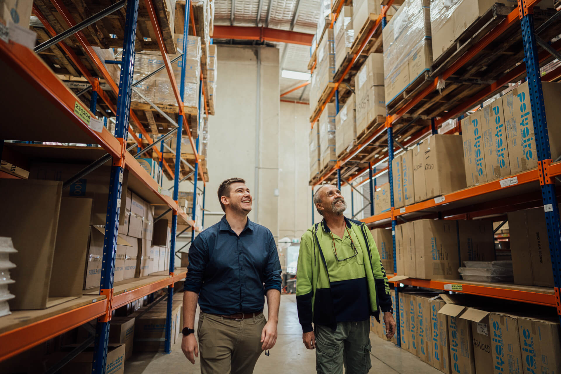 two men walking through a warehouse