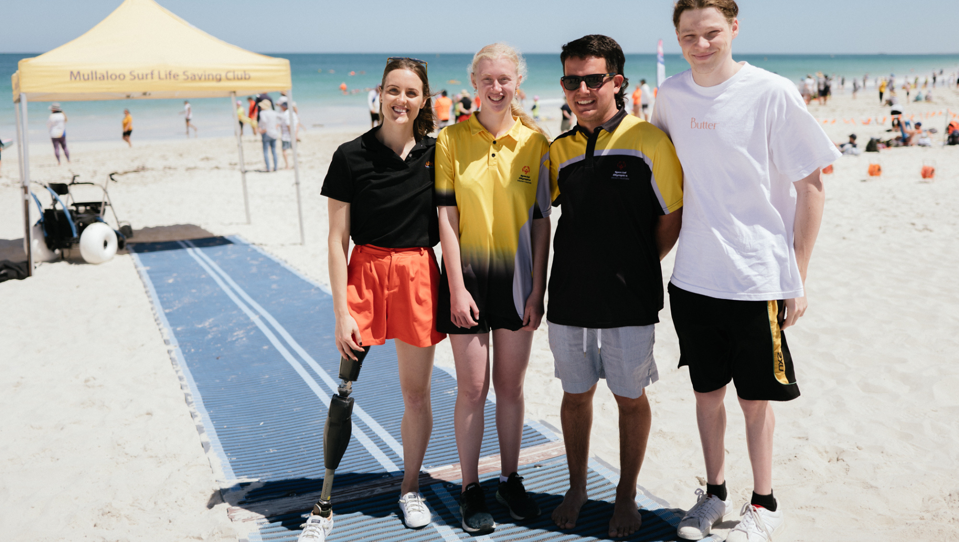 Ellie Cole standing with Special Olympic Swimmers Maddison & Max, with Paralympian Ben Popham