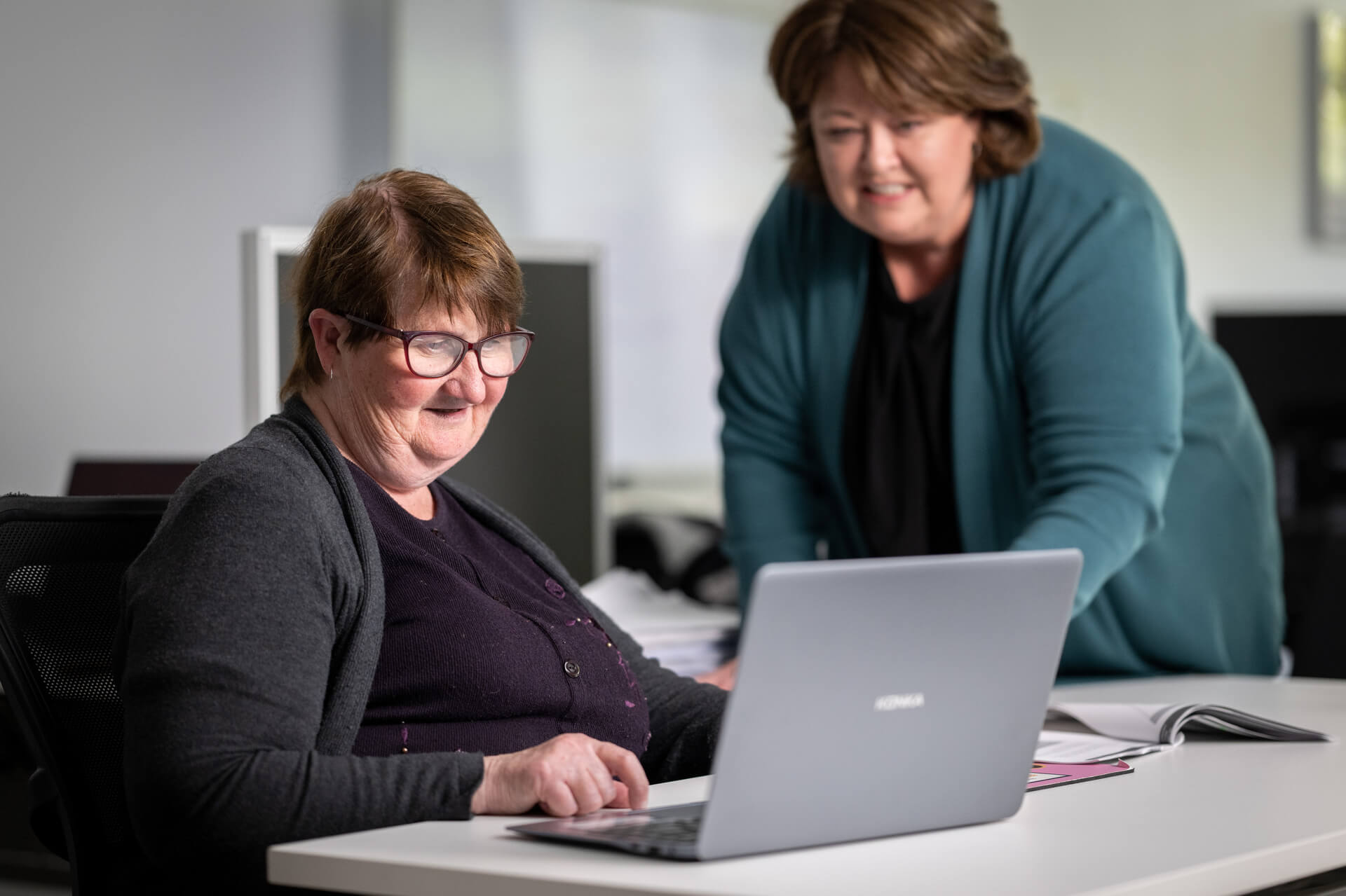 Ruth on the computer with another woman