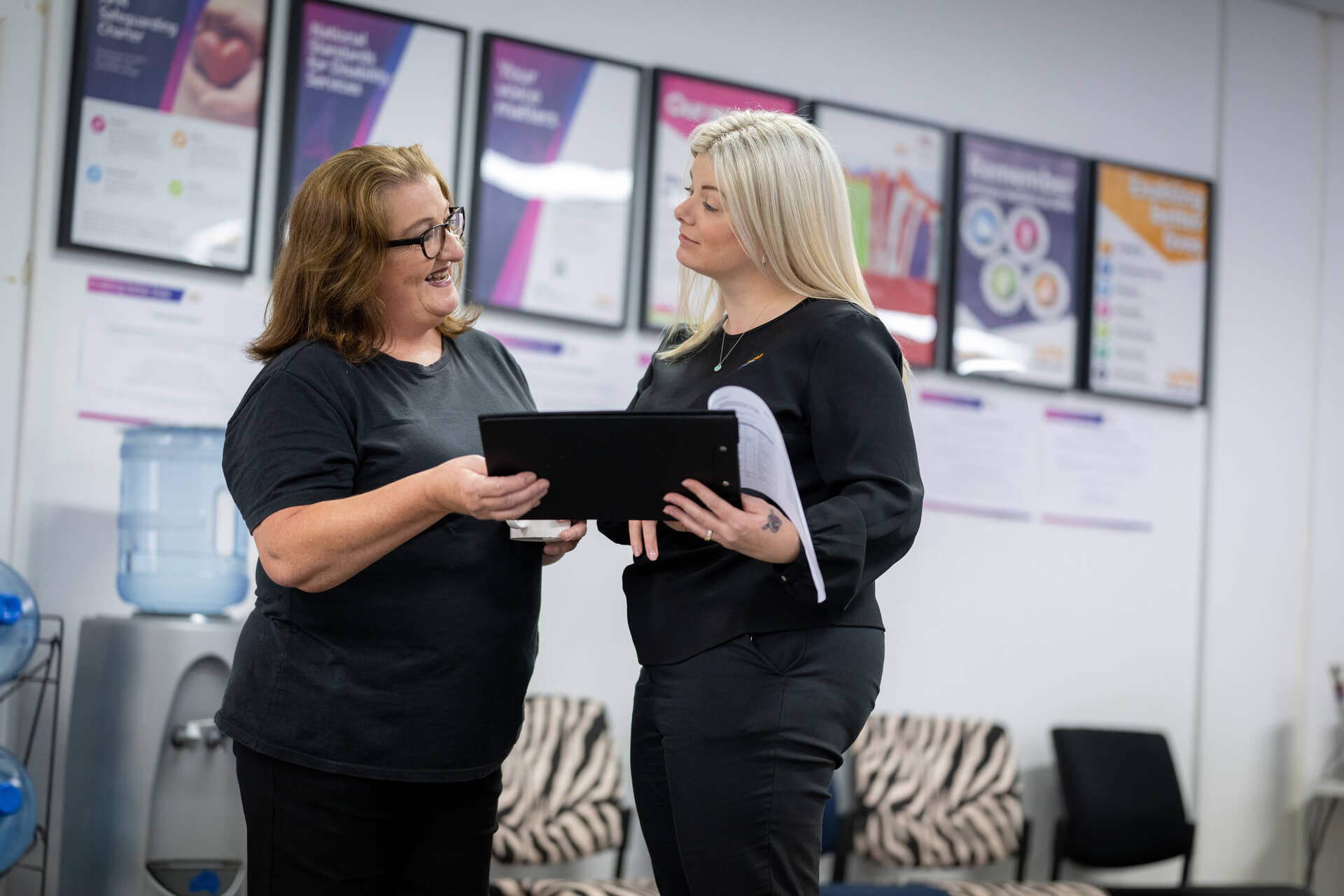 Robyn discussing with a woman in the workplace