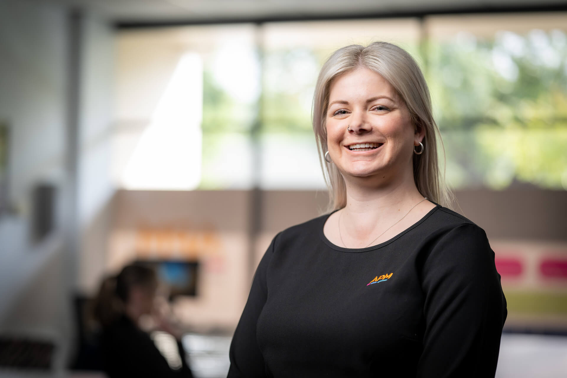 Employer Margaret smiles in a corridor