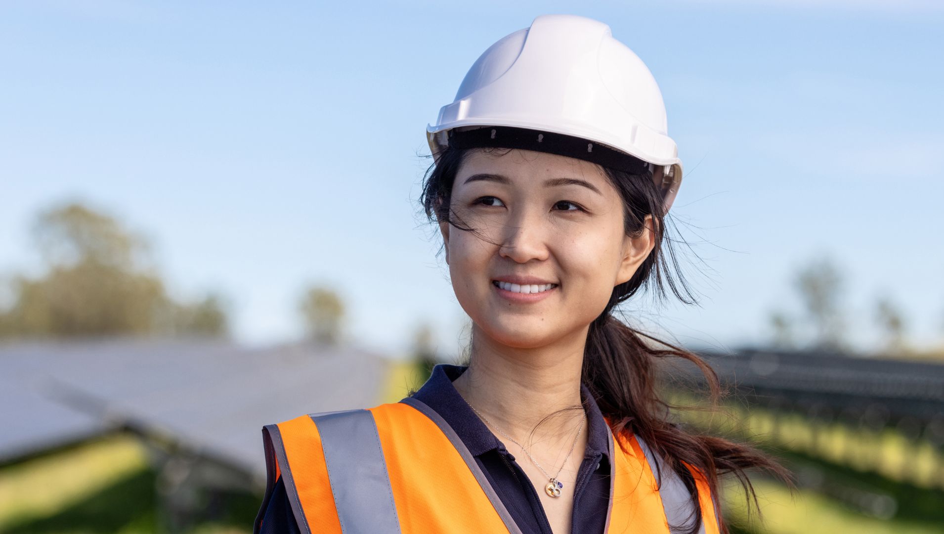 A young female participant smiles in a truck yard