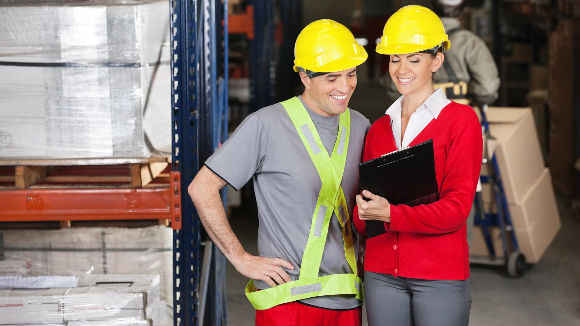 A young man receiving on the job training in a factory