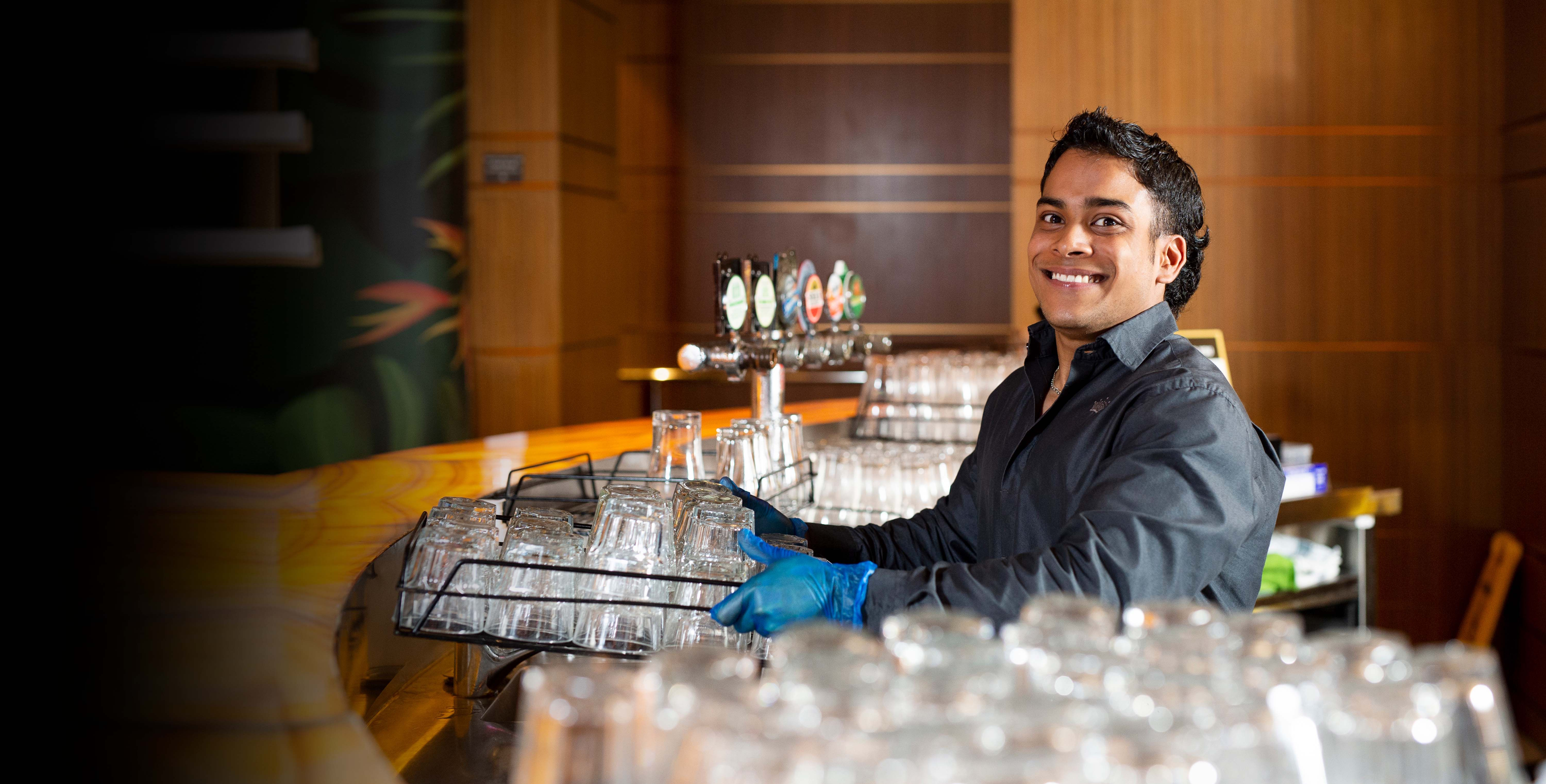 Job seeker smiling behind a bar on the cover of disability report