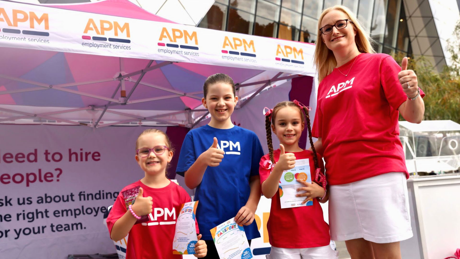 A woman and three young children in APM tops celebrate Telethon