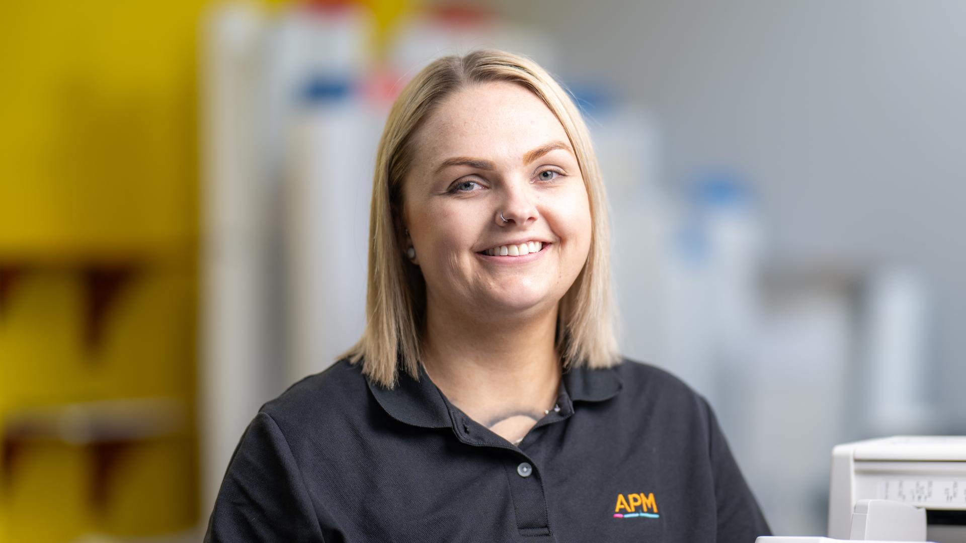 APM employment consultant in a black APM polo