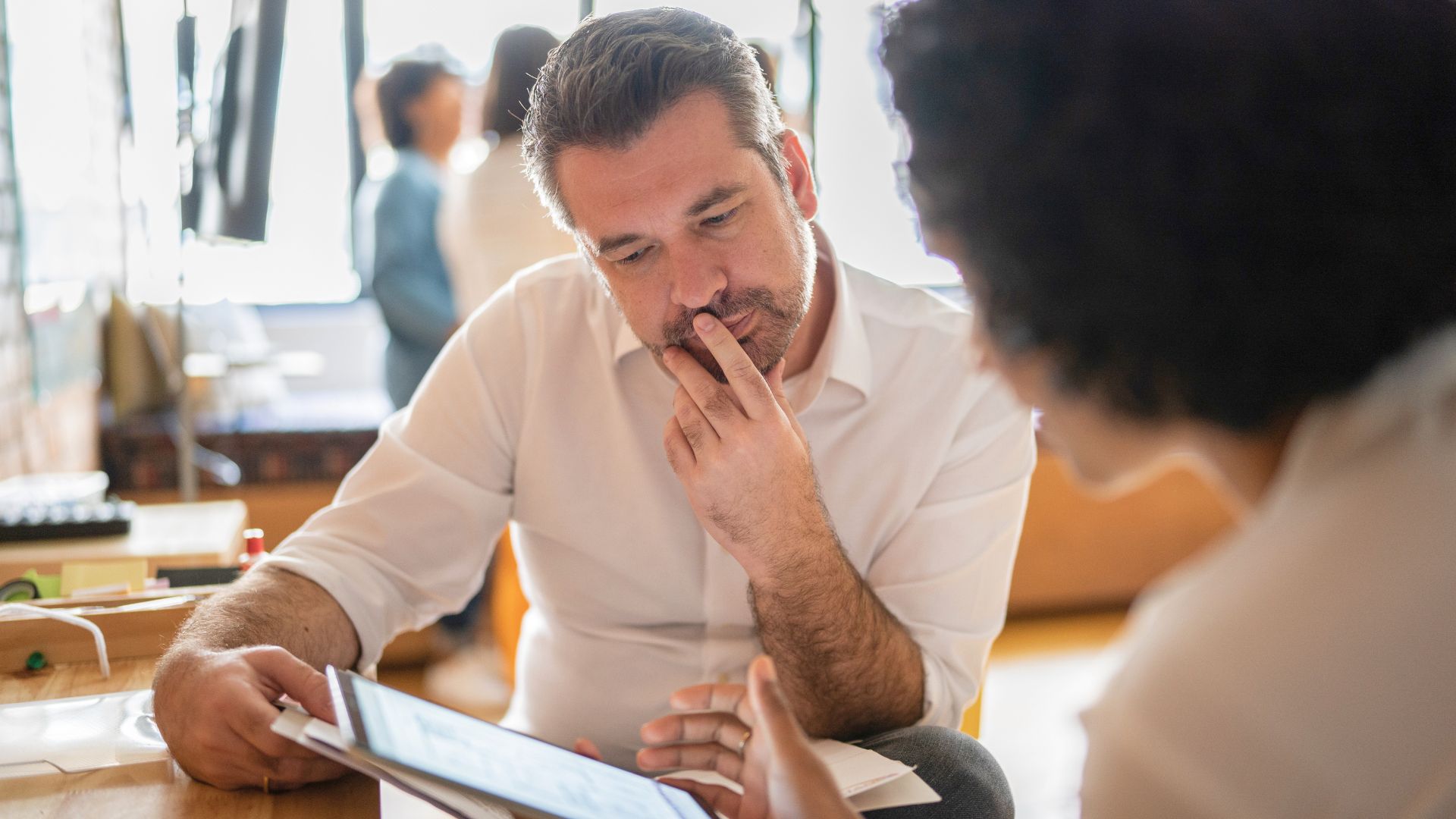 Person reviewing documents with a consultant during a job support appointment