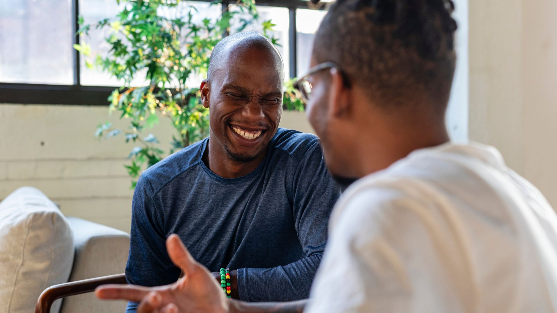 Two men talk during a counselling session