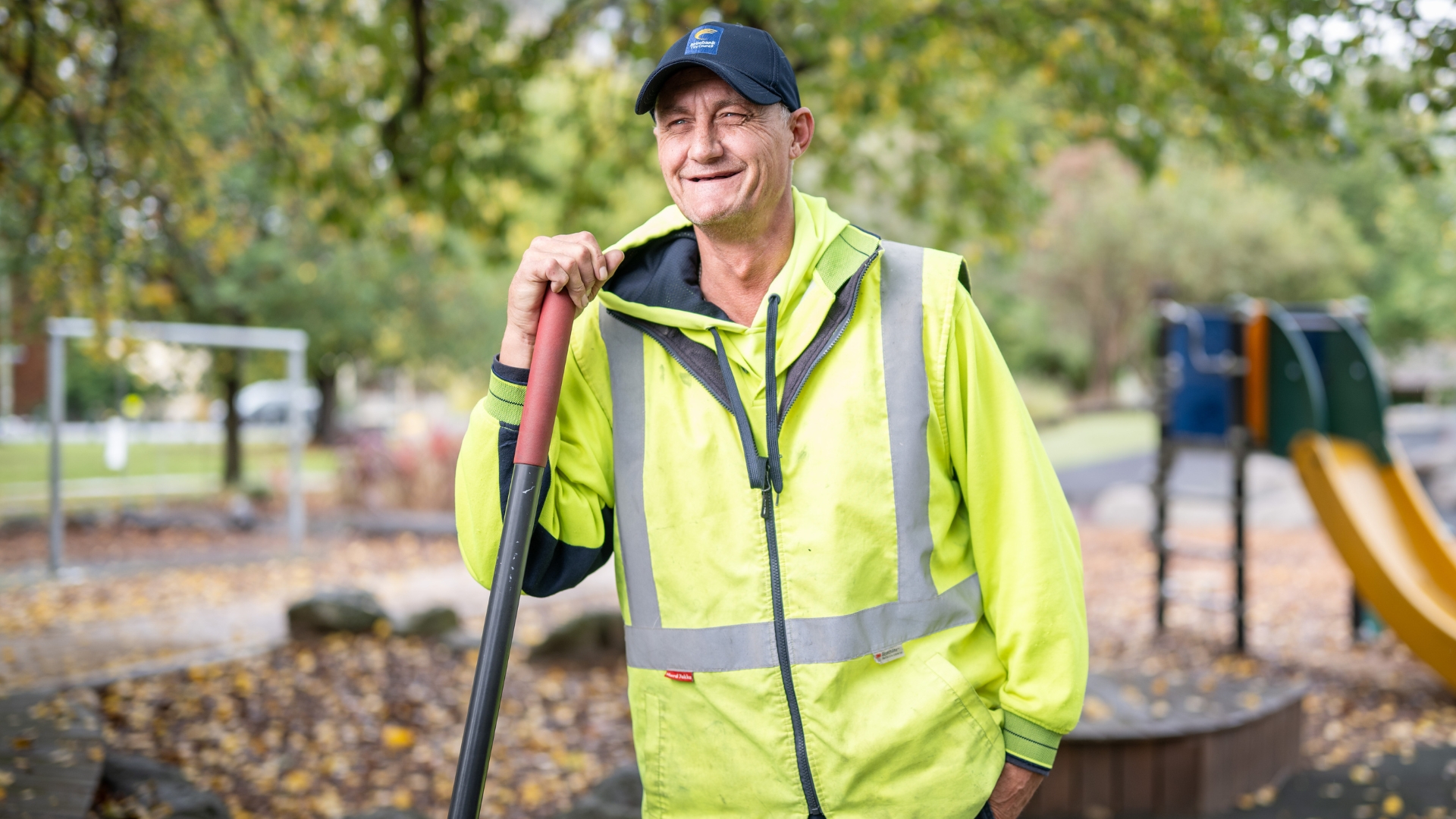 Paul standing in a community park while working in grounds maintenance, highlighting sustainable employment and workforce participation supported by Inclusive Employment Australia and APM Employment Services.