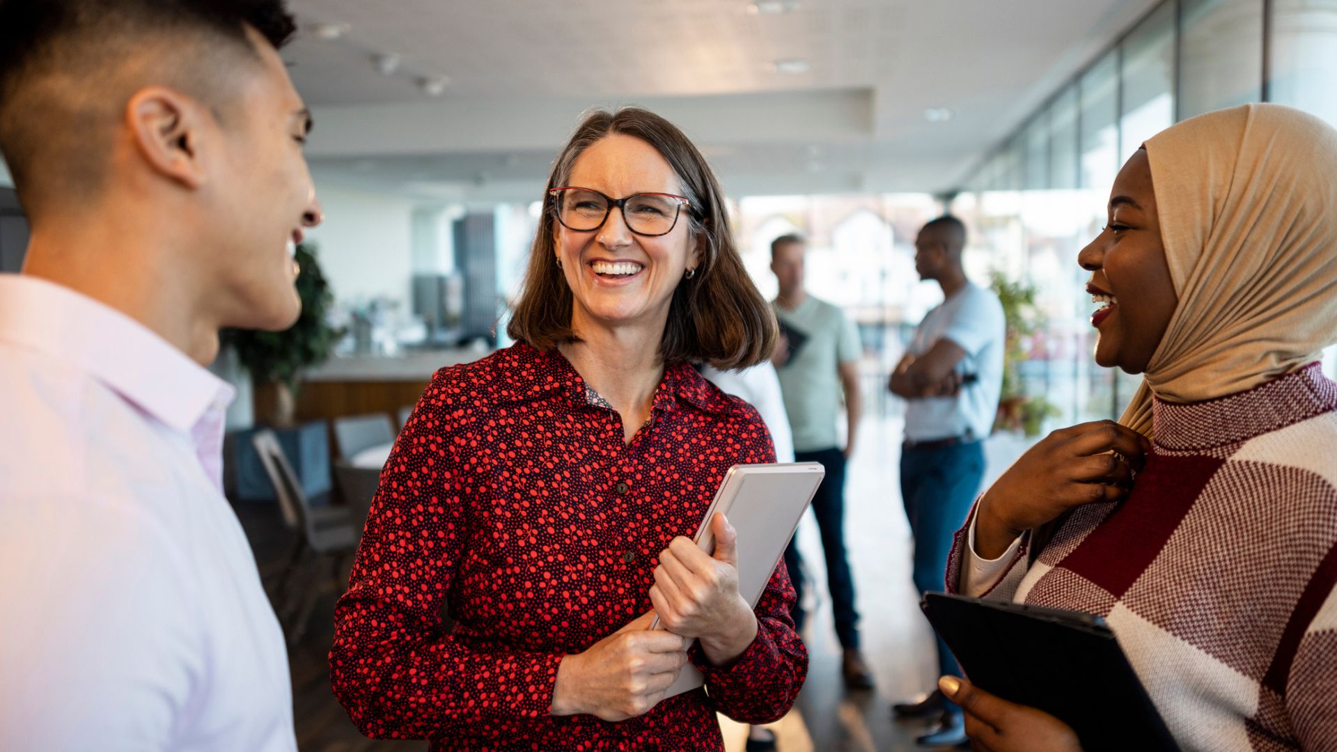 Woman smiles talking to colleagues