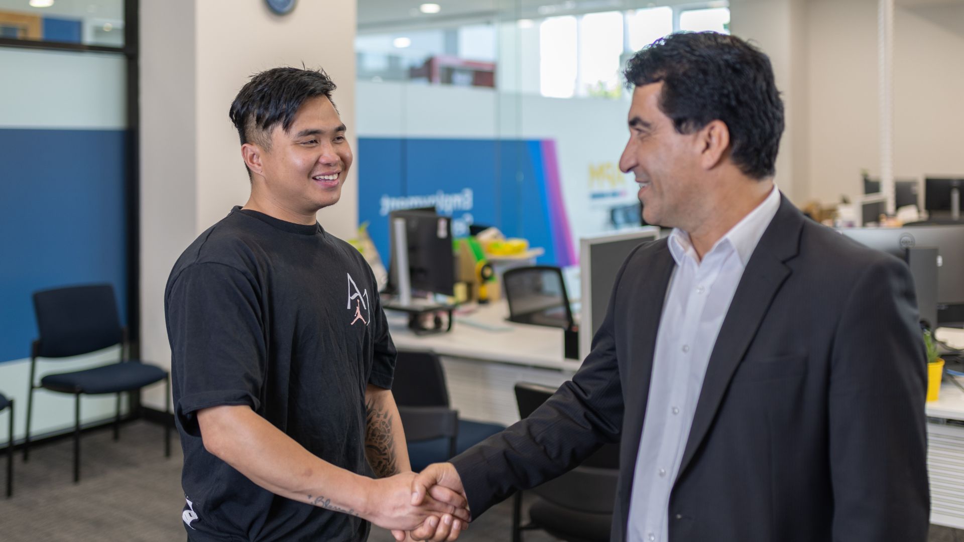 A Workforce Australia participant shakes hands with an APM manager