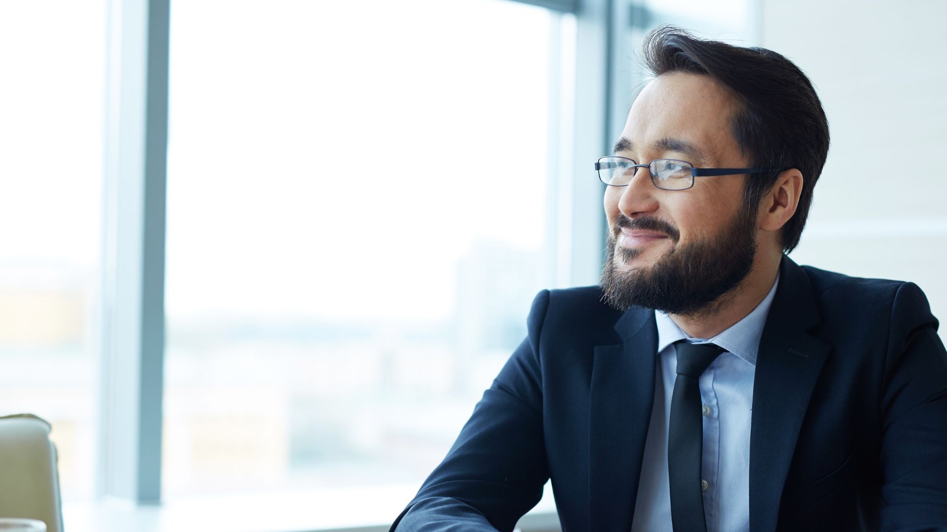 A man looks out of his window in an office